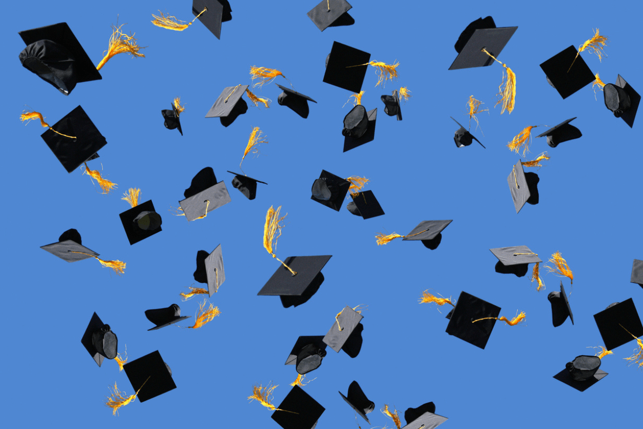 Graduation caps thrown into air